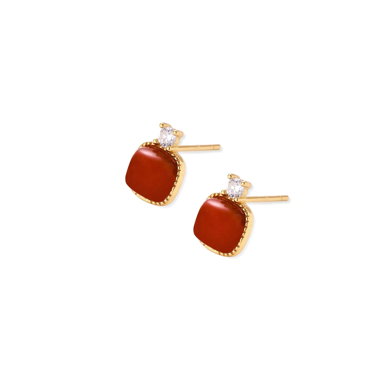 18K gold vermeil stud earrings with cushion-cut red agate stones and sparkling crystal accents on beige background