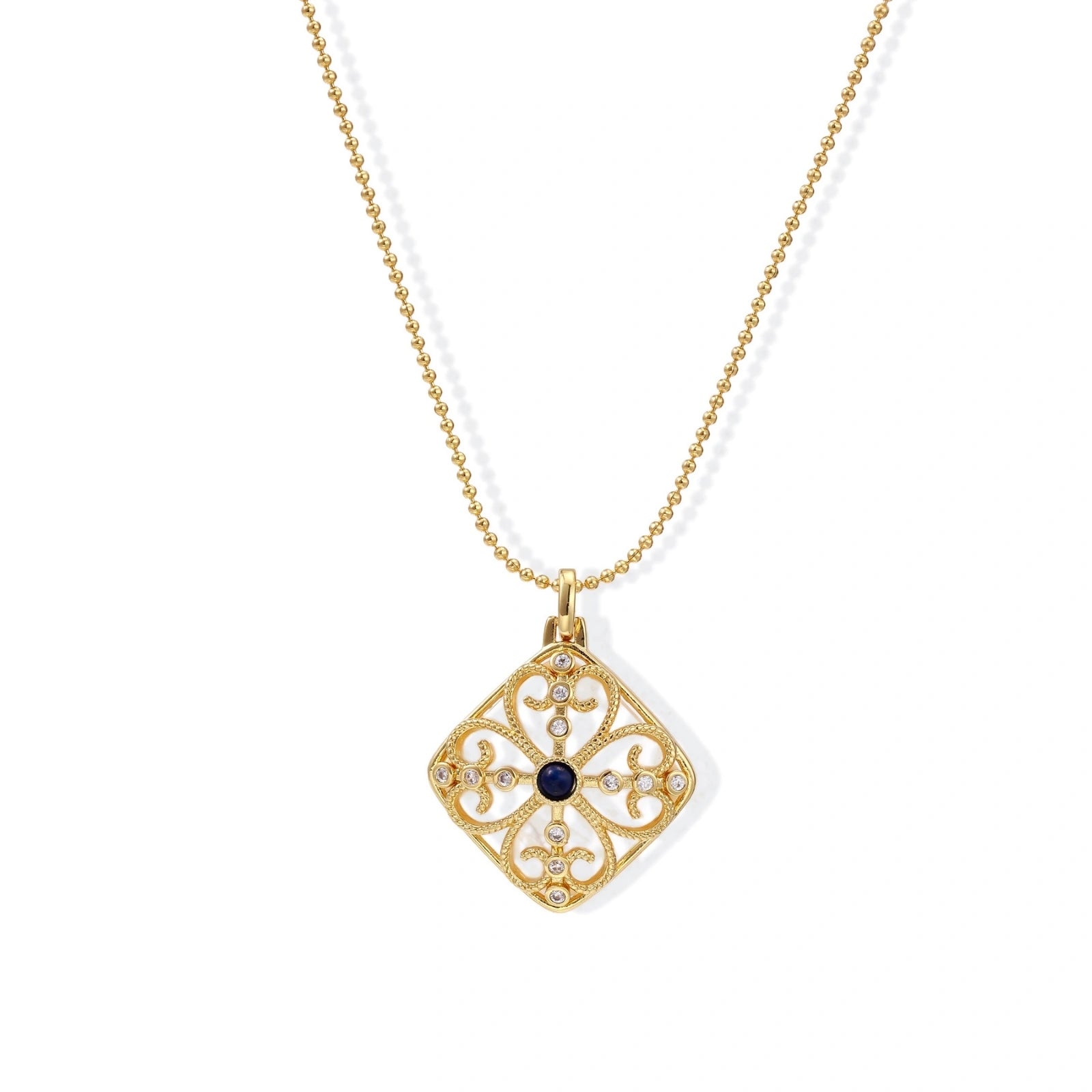 Gold filigree pendant with quatrefoil design, deep blue lapis lazuli center, clear crystal accents on ball chain