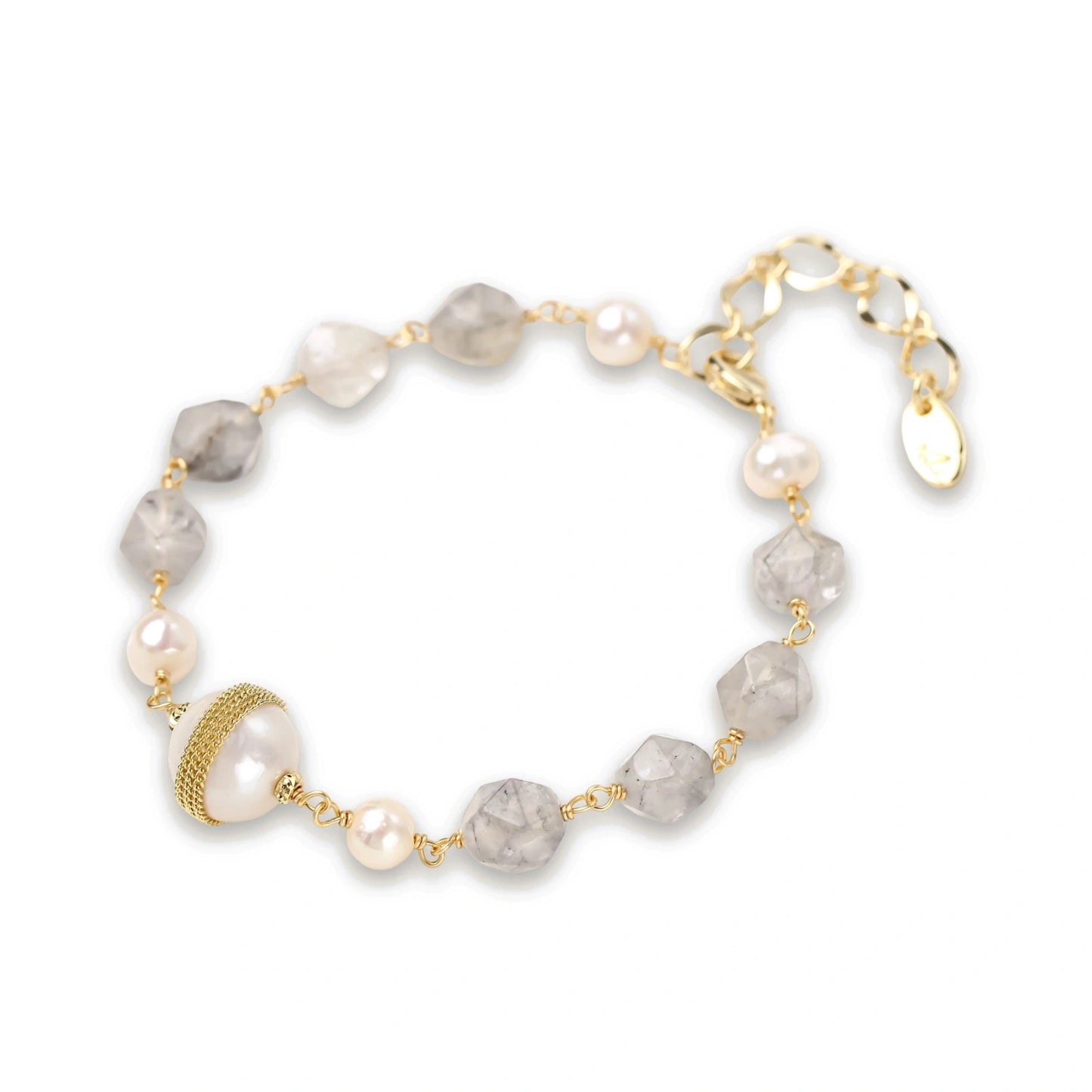 Bracelet with cloudy quartz beads, freshwater pearls, and gold-wrapped baroque pearl centerpiece on white background.