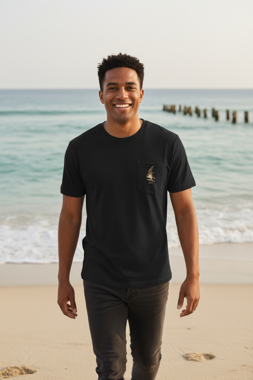 Happy male model wearing Osprey and Weakfish t-shirt walking toward camera in coastal setting